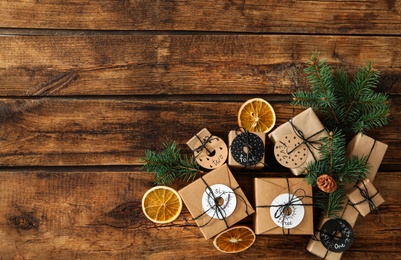 Photo of Gift boxes and festive decor on wooden table, flat lay with space for text Christmas advent calendar