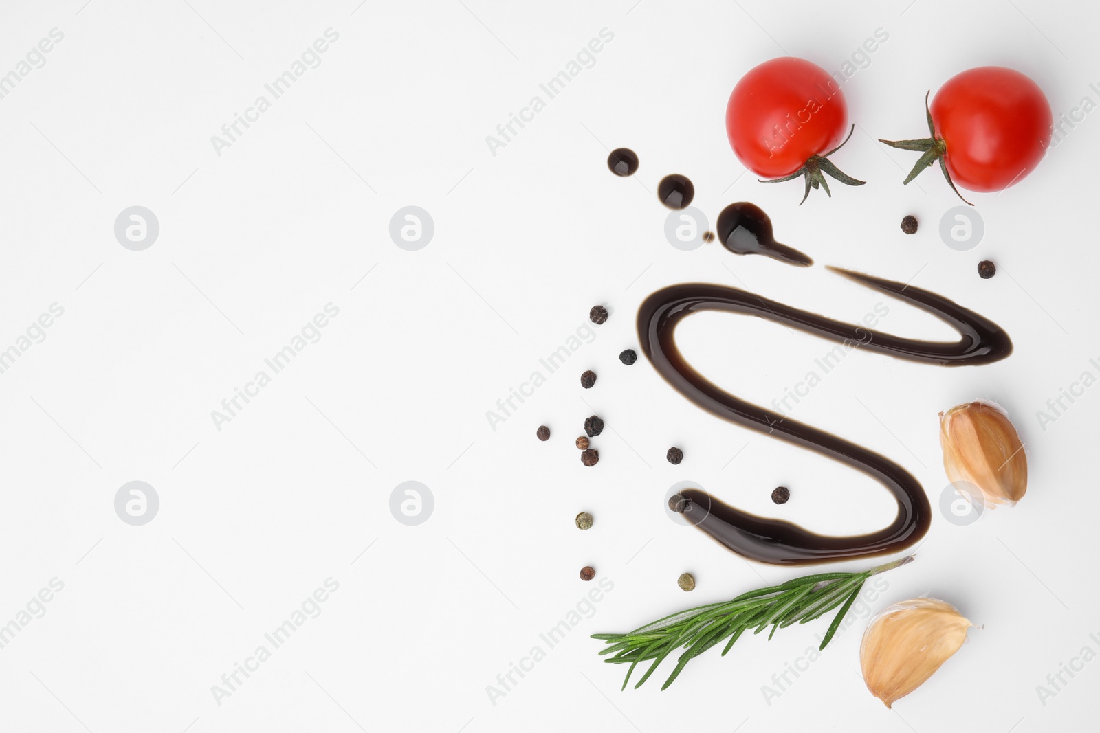 Photo of Organic balsamic vinegar and cooking ingredients on white background, flat lay. Space for text