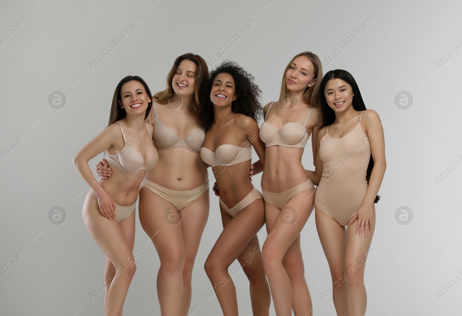 Photo of Group of women with different body types in underwear on light background