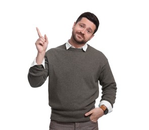 Portrait of handsome bearded businessman pointing at something on white background