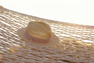 Photo of Hammock with hat hanging outdoors. Time to relax