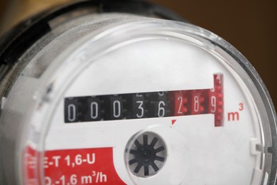 Electric meter on blurred background, closeup view. Water measuring device