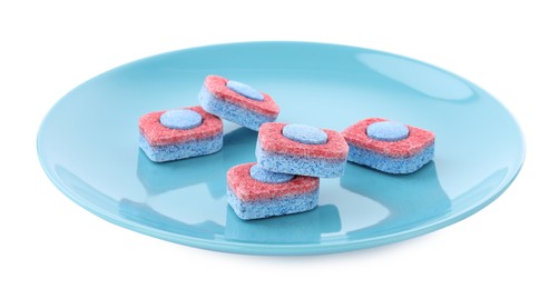 Photo of Light blue plate with dishwasher detergent tablets on white background