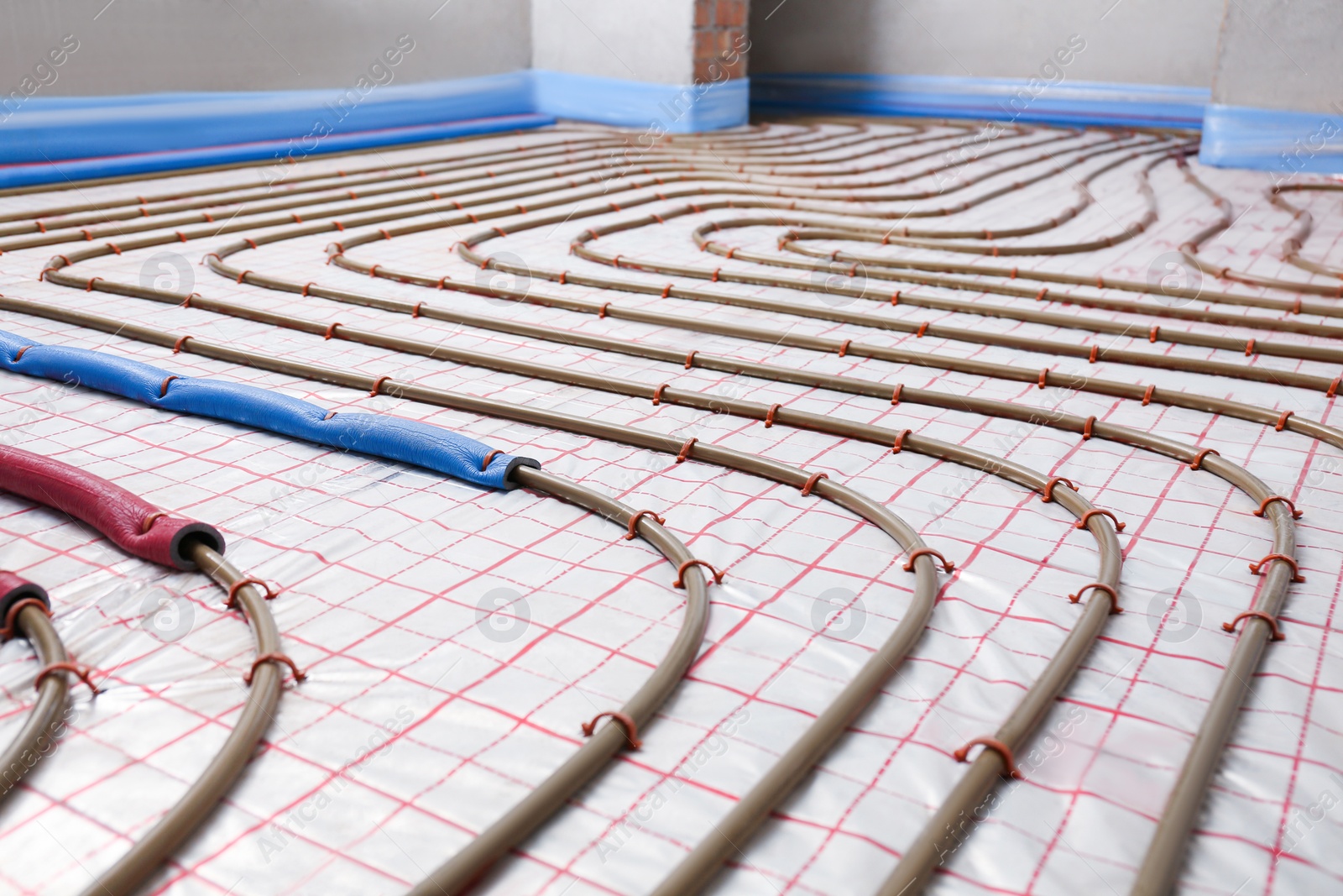 Photo of Installation of underfloor heating system in building