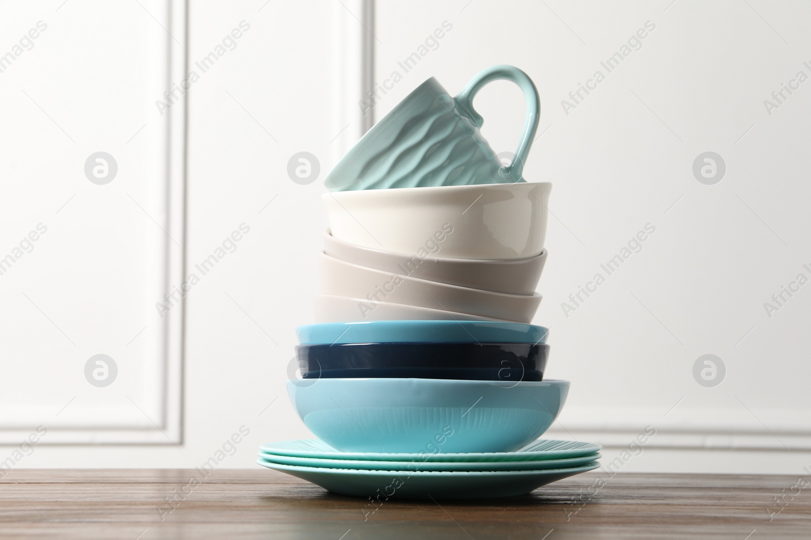 Photo of Beautiful ceramic dishware and cup on wooden table