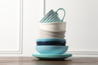 Photo of Beautiful ceramic dishware and cup on wooden table