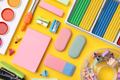 Many different school stationery on yellow background, flat lay. Back to school