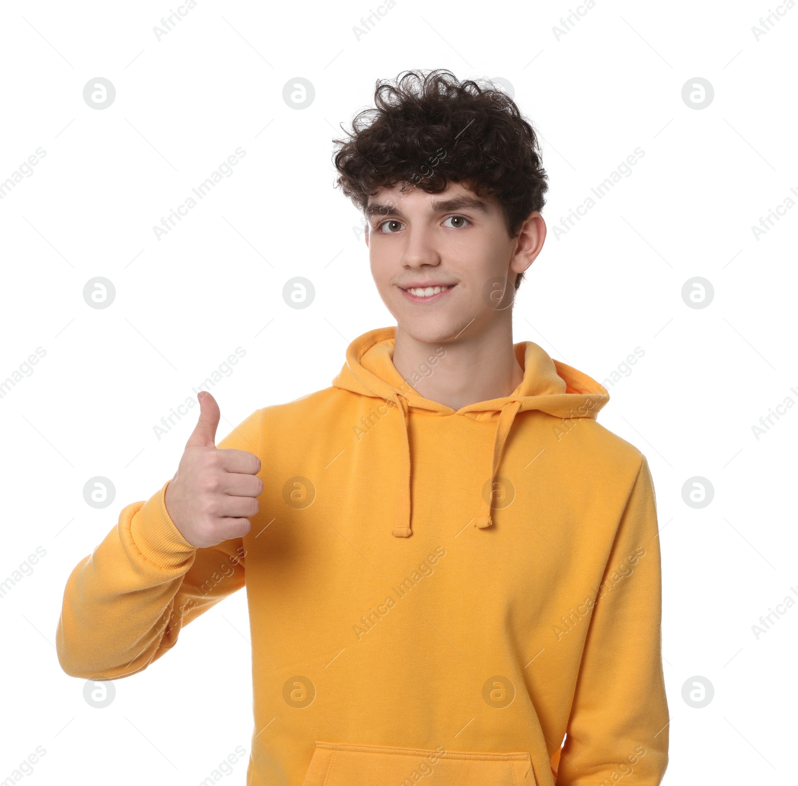 Photo of Portrait of smiling teenage boy showing thumb up on white background