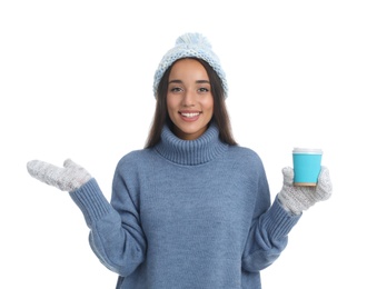 Happy beautiful woman with paper cup of mulled wine on white background