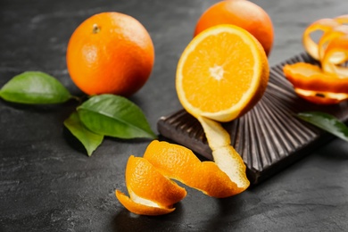 Orange fruits with peel on black table