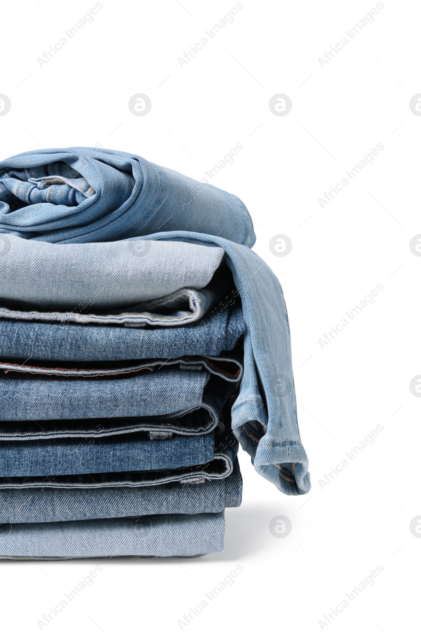 Image of Stack of different folded jeans isolated on white