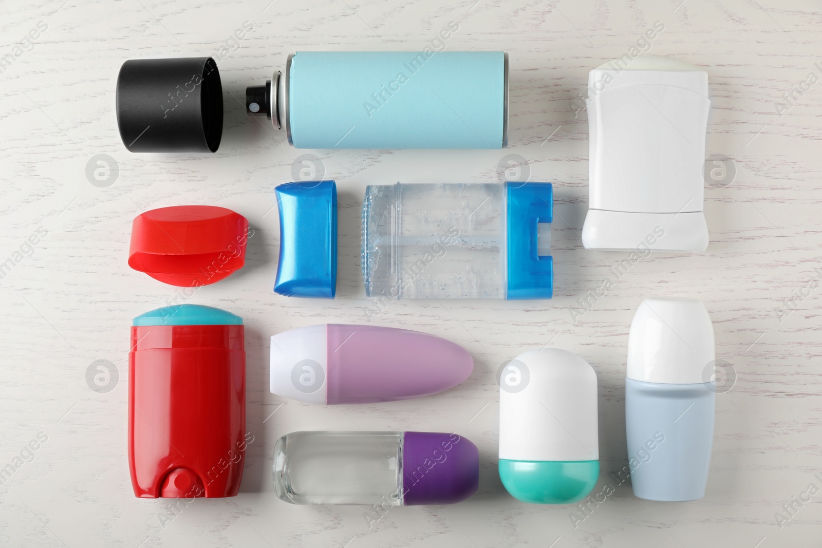 Photo of Flat lay composition with different deodorants on white wooden table