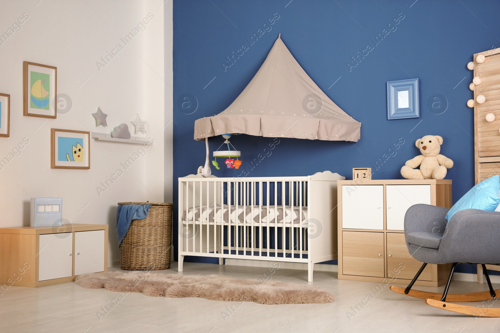 Photo of Stylish baby room interior with crib