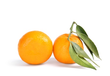 Photo of Tasty ripe tangerines with leaves on white background