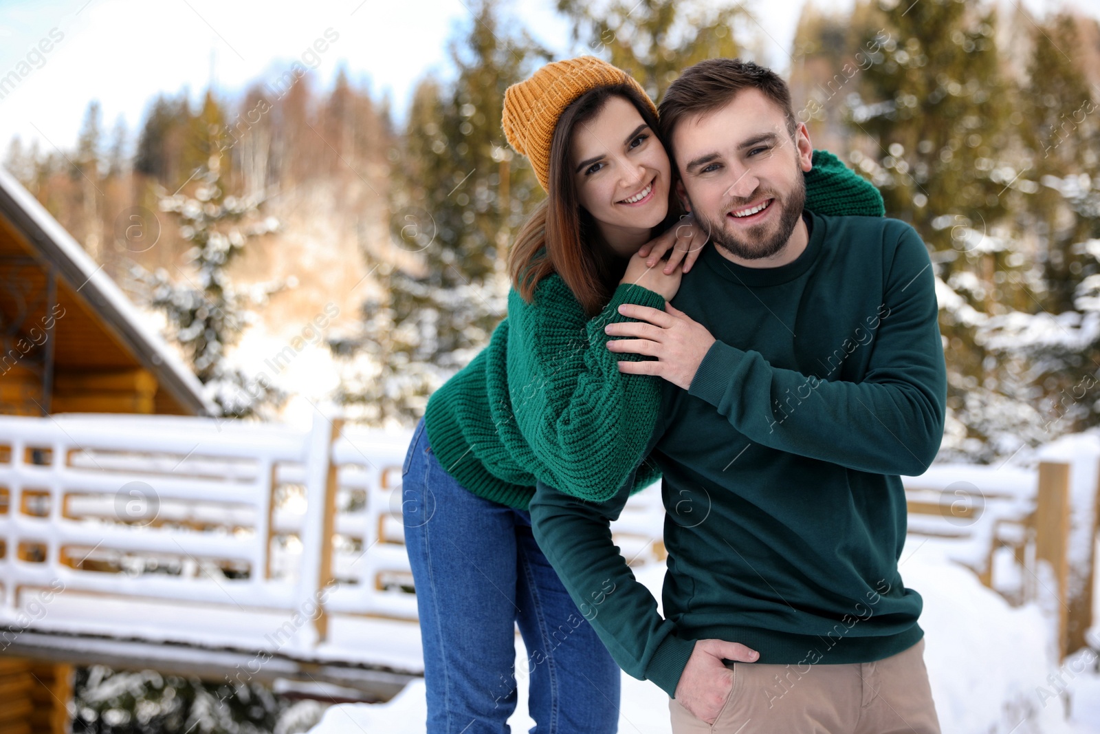 Photo of Lovely couple spending time together on snowy day. Winter vacation