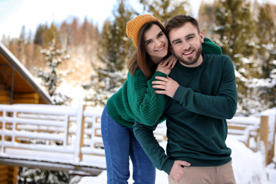 Photo of Lovely couple spending time together on snowy day. Winter vacation