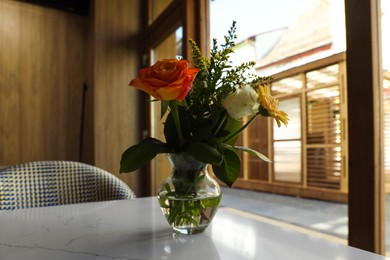 Photo of Bouquet of beautiful flowers on table indoors