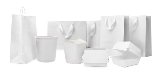 Image of Set with paper bags and containers for food on white background