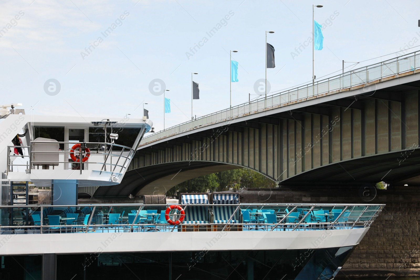 Photo of Modern ferry ship near bridge on sunny day