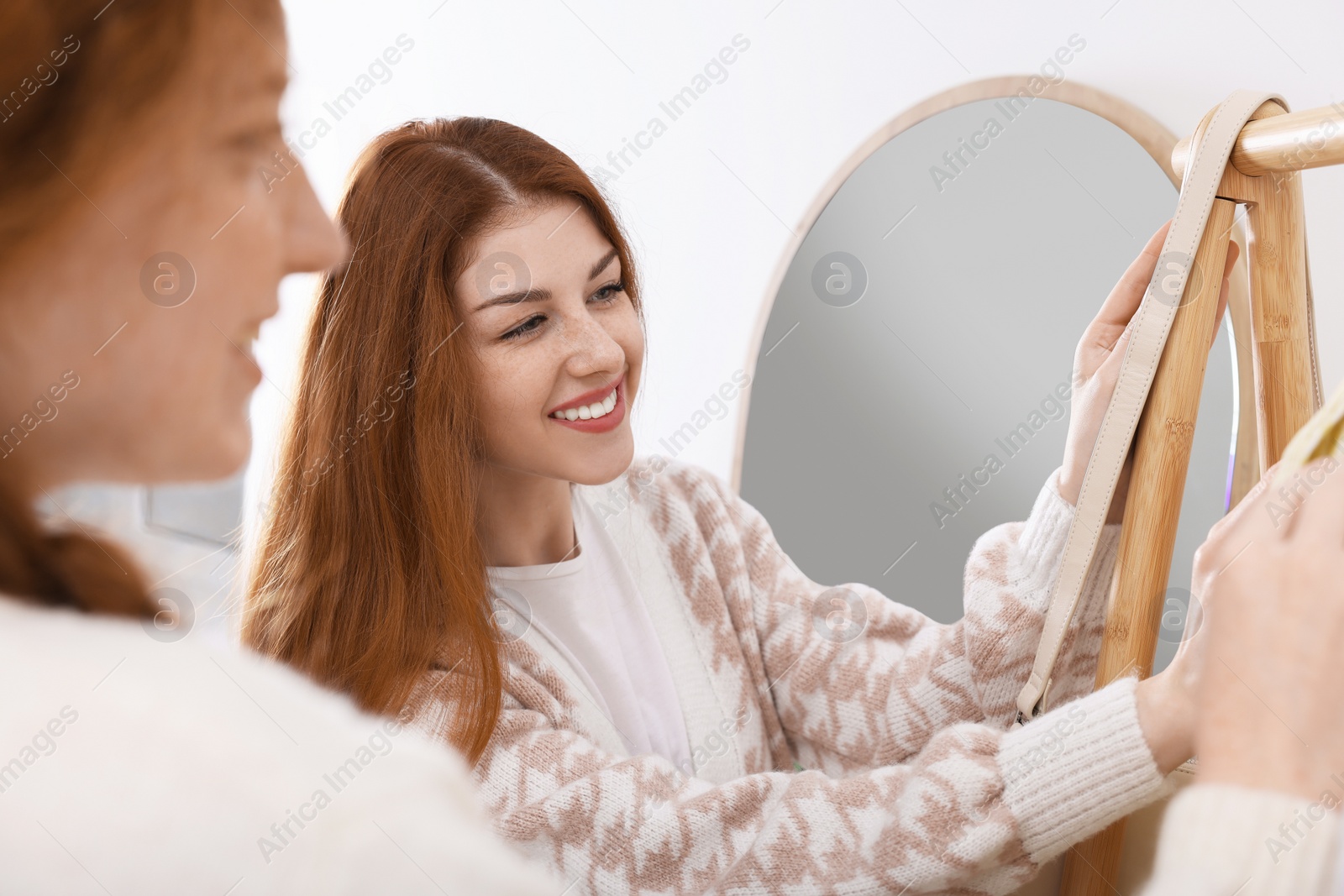 Photo of Beautiful young sisters shopping together in boutique, closeup