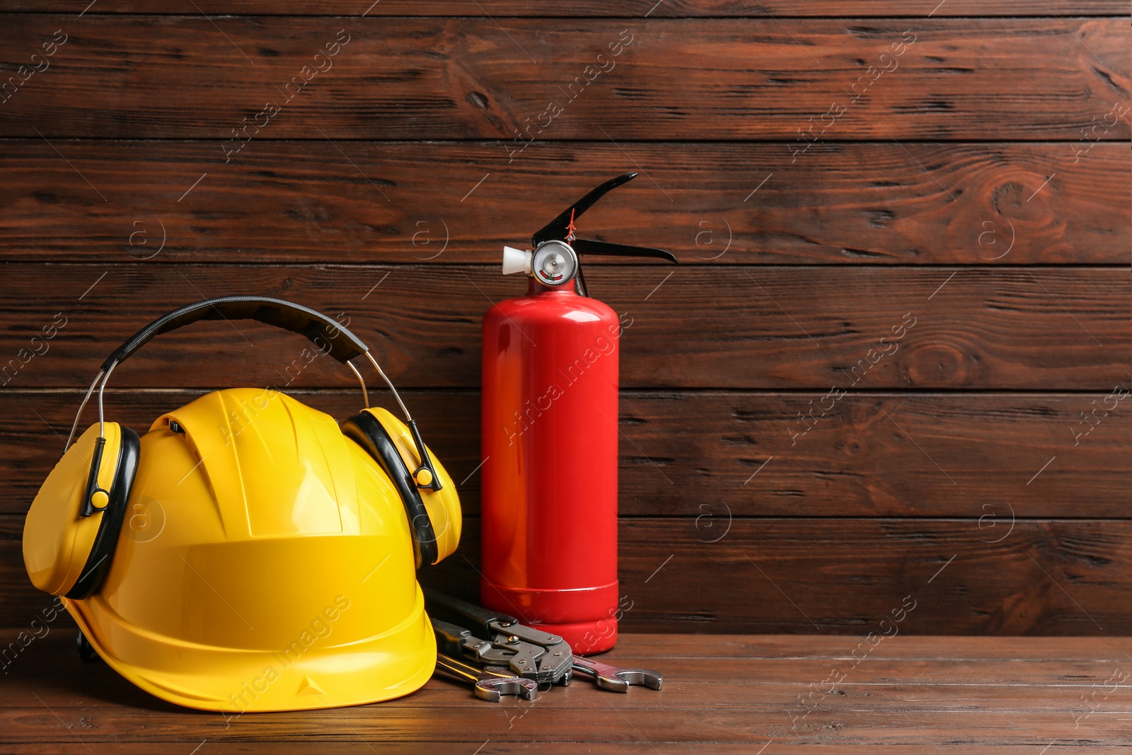 Photo of Composition with construction tools on table against wooden background, space for text