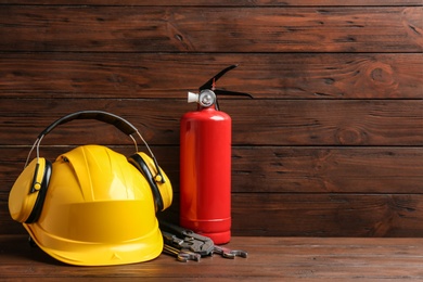 Photo of Composition with construction tools on table against wooden background, space for text