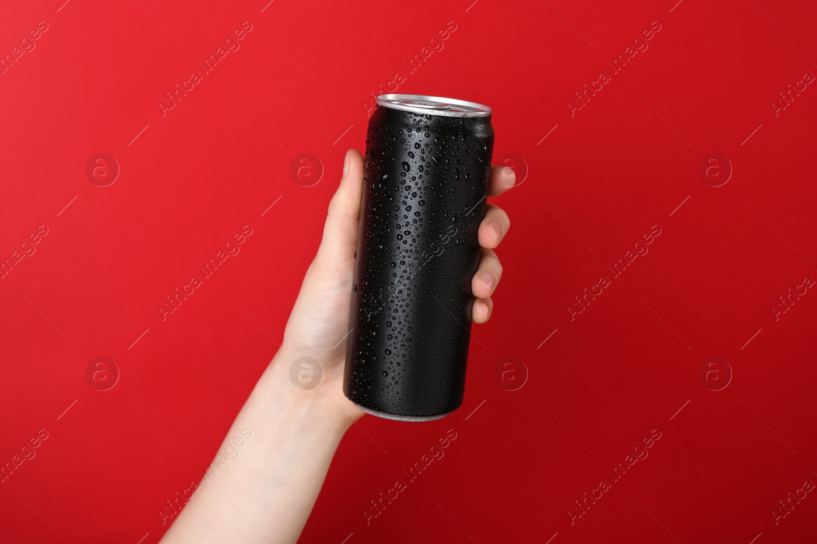 Photo of Woman with energy drink on red background, closeup