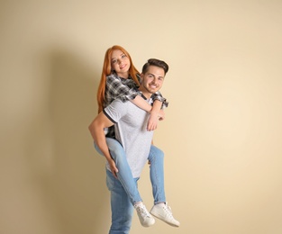 Photo of Young couple in stylish jeans on light background