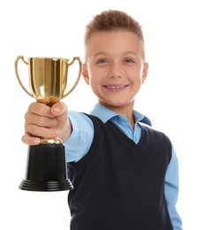 Photo of Happy boy in school uniform with golden winning cup isolated on white