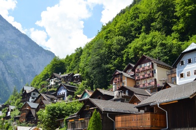 Photo of Picturesque view of town with beautiful buildings near mountains