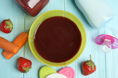 Photo of Flat lay composition with healthy baby food and ingredients on light blue wooden table