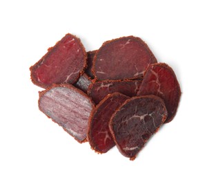 Photo of Delicious dry-cured beef basturma slices on white background, top view