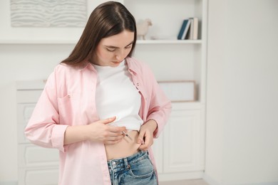 Photo of Diabetes. Woman making insulin injection into her belly at home, space for text