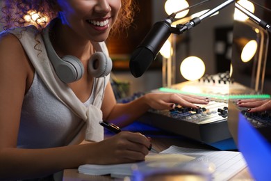 African American woman working as radio host in modern studio, closeup