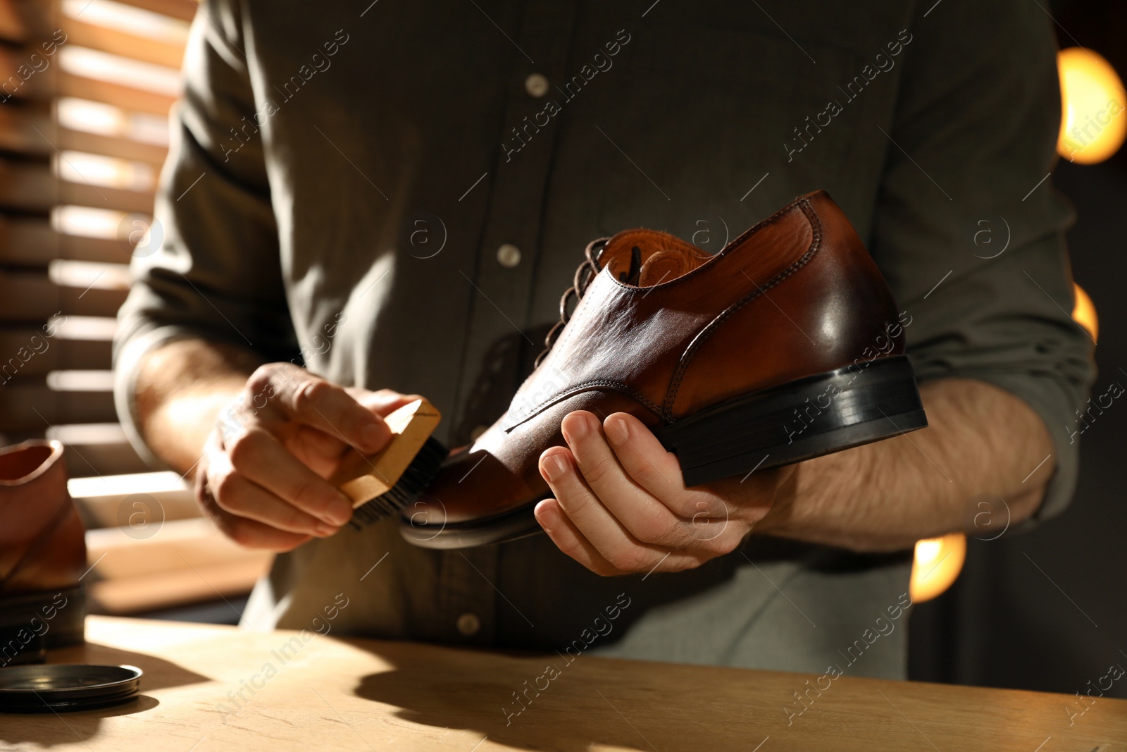 Photo of Master taking care of shoes in his workshop, closeup