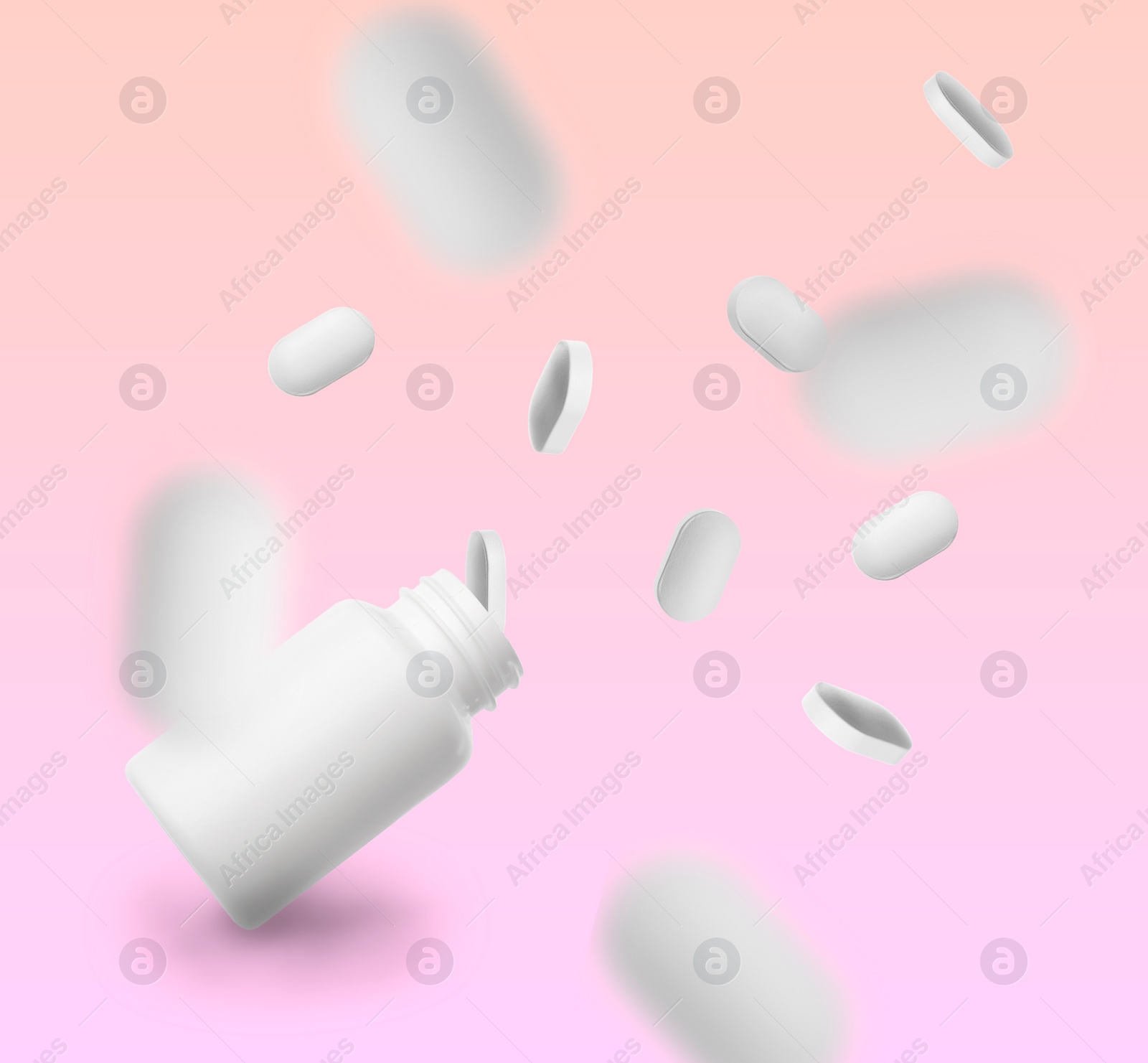 Image of Vitamin pills and bottle in air against color background