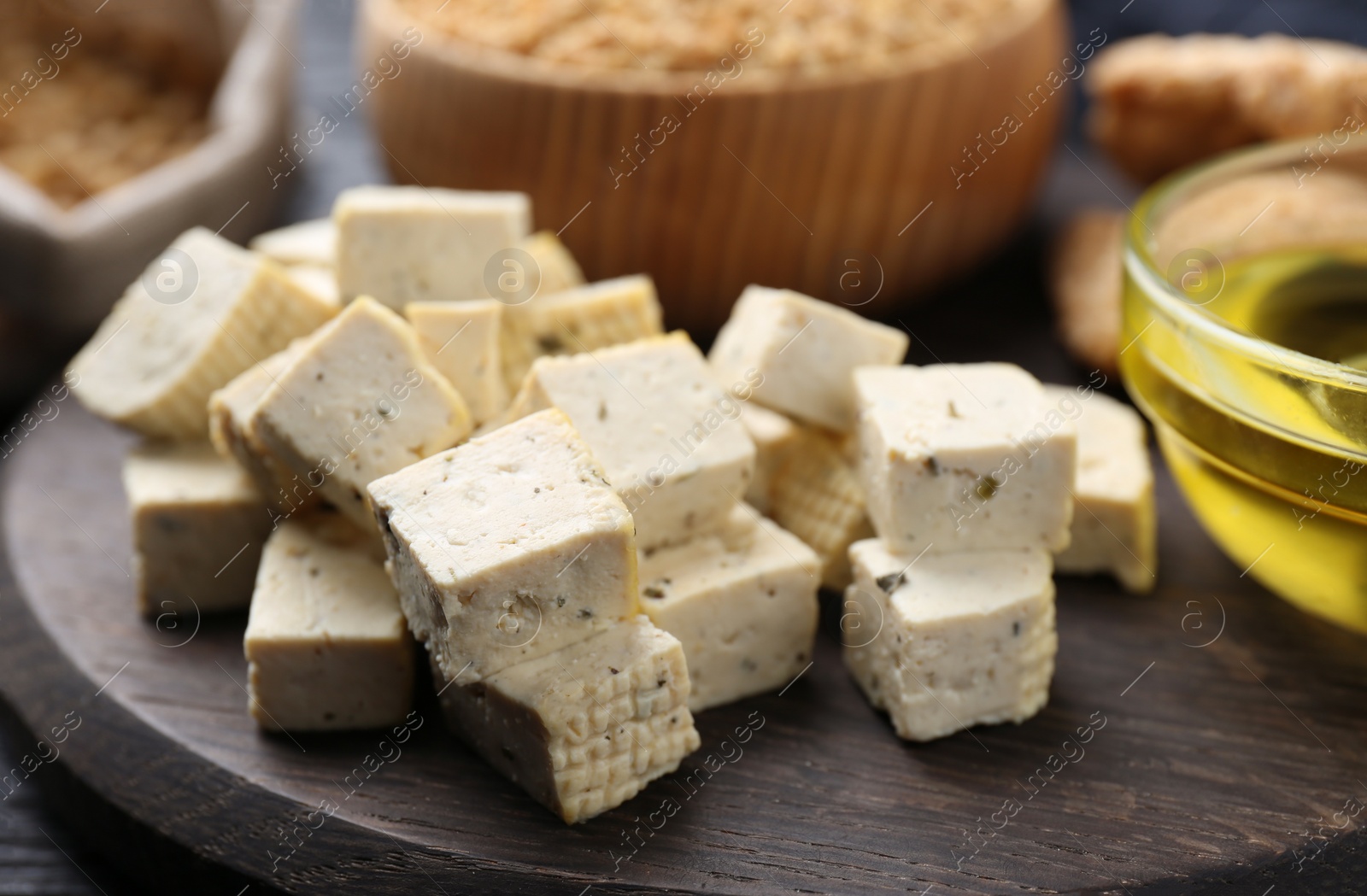 Photo of Natural tofu on wooden board, closeup. Soy product