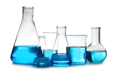 Photo of Laboratory glassware with liquid on table against white background. Chemical analysis