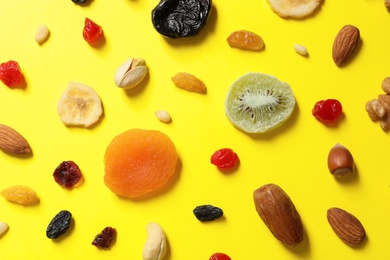 Photo of Flat lay composition of different dried fruits and nuts on color background