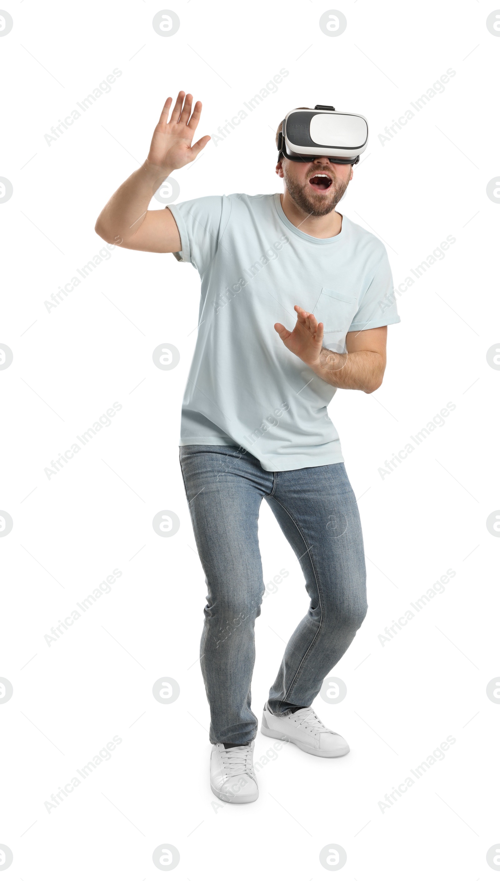 Photo of Emotional man using virtual reality headset on white background