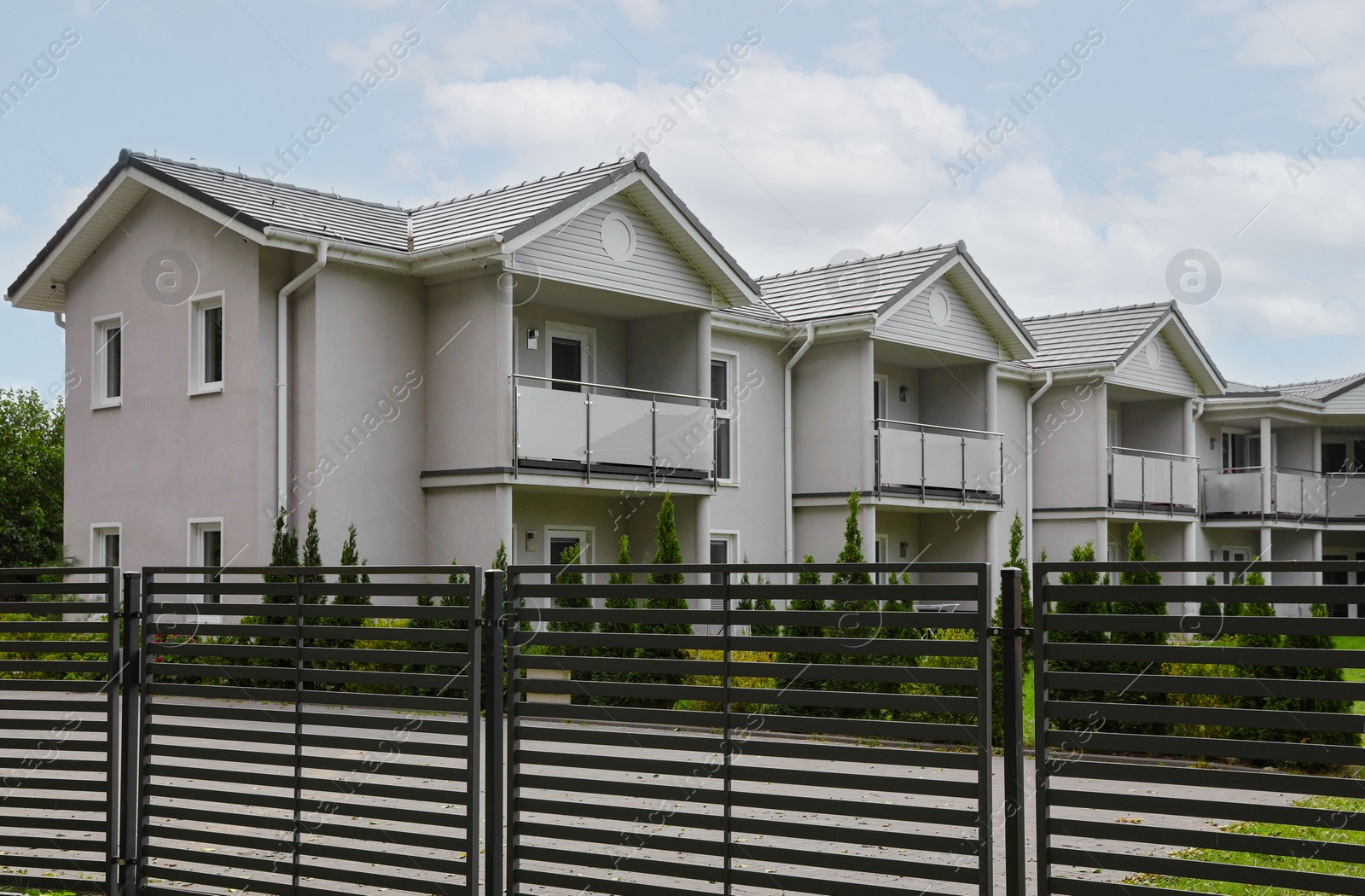 Photo of Beautiful view of white houses behind fence