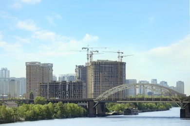 Photo of Beautiful view of cityscape with modern buildings and bridge over river