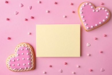 Photo of Flat lay composition with heart shaped cookies and blank card on color background, space for text