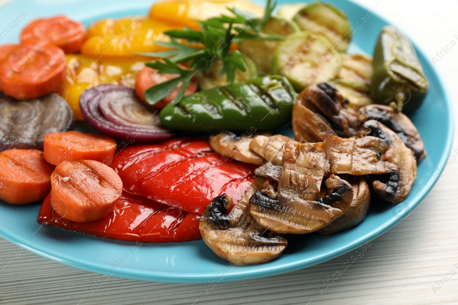 Photo of Delicious grilled vegetables on white wooden table, closeup