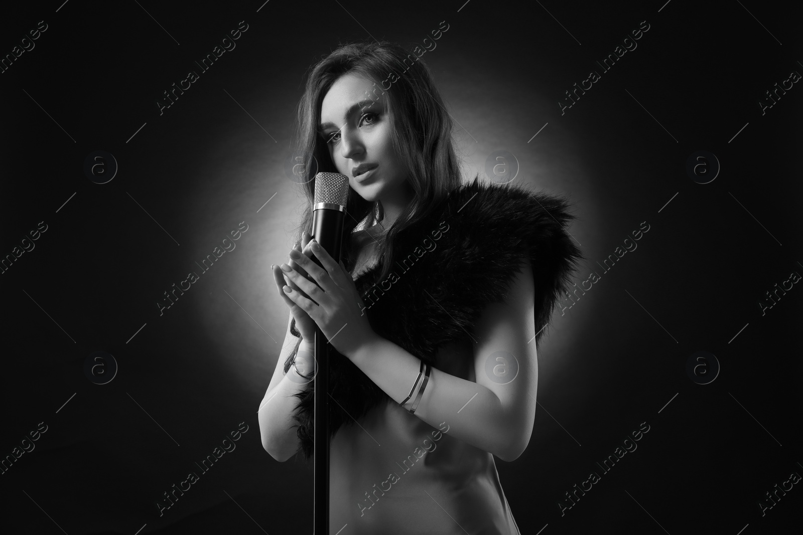 Image of Beautiful singer with microphone, black and white effect