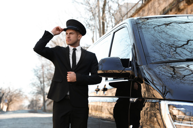 Photo of Professional driver near luxury car. Chauffeur service