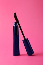 Photo of Mascara for eyelashes on bright pink background