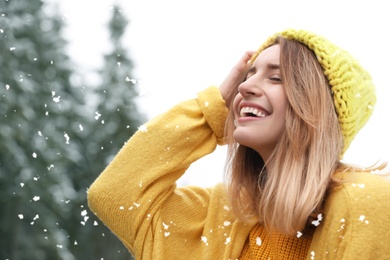 Photo of Young woman in warm clothes outdoors on snowy day. Winter vacation