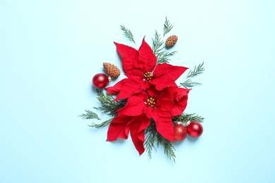 Photo of Flat lay composition with poinsettia on color background. Traditional Christmas flower