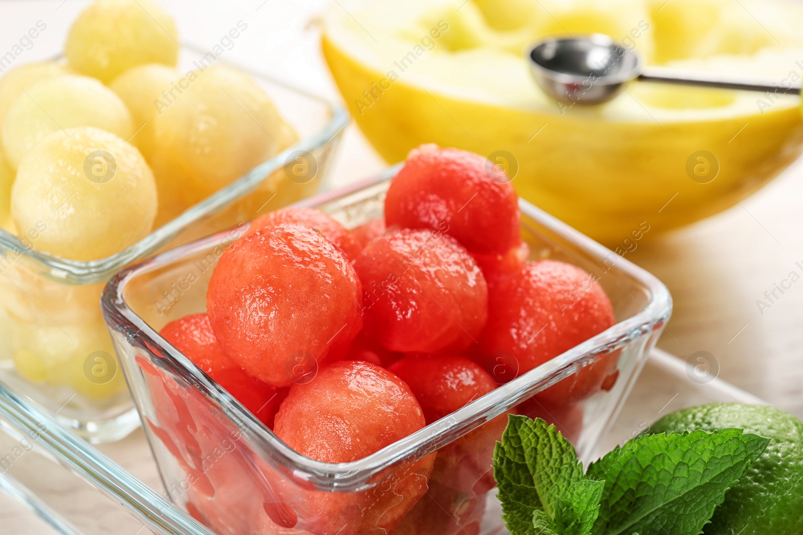 Photo of Melon and watermelon balls with mint served on table, closeup